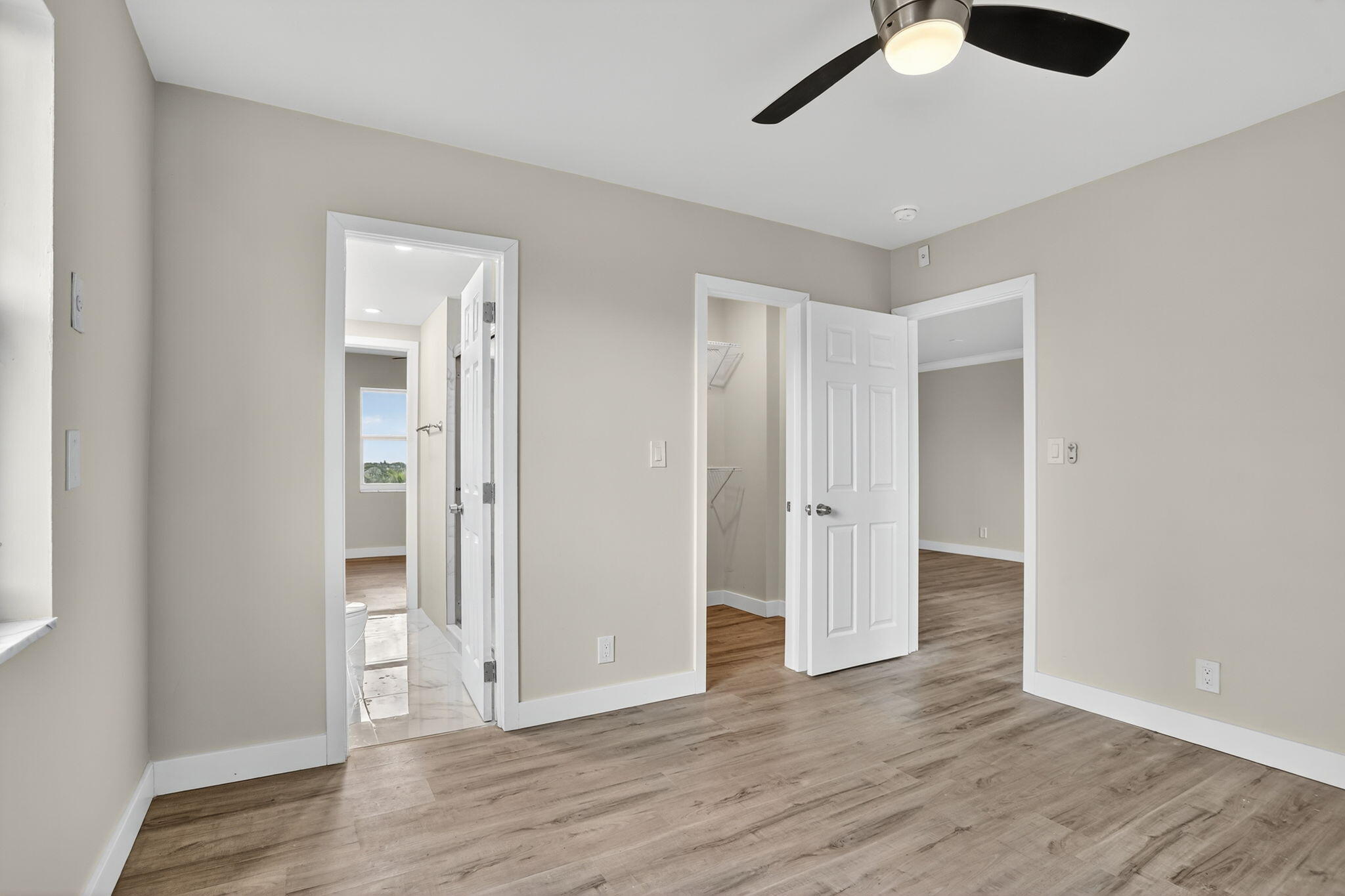 3201 Northeast 14th Street Causeway, Unit 501 Pompano Beach, FL 33062 - Photo 25 of 32 an empty room with wooden floor and windows
