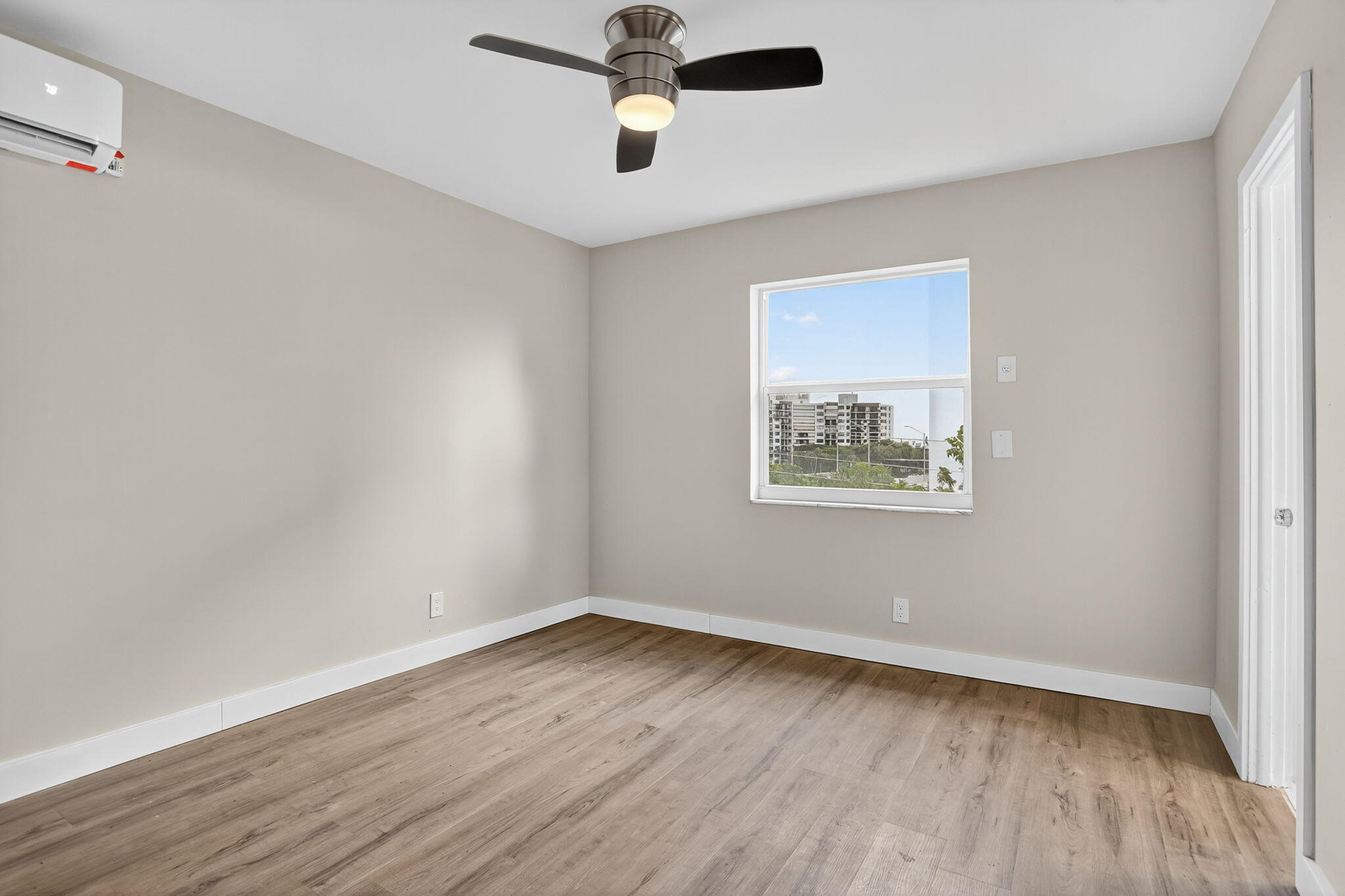 3201 Northeast 14th Street Causeway, Unit 501 Pompano Beach, FL 33062 - Photo 27 of 32 an empty room with wooden floor and ceiling fan