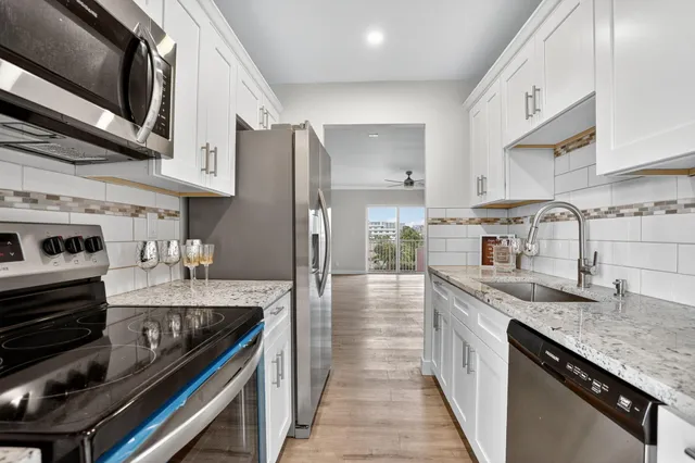 a kitchen with granite countertop a sink and cabinets