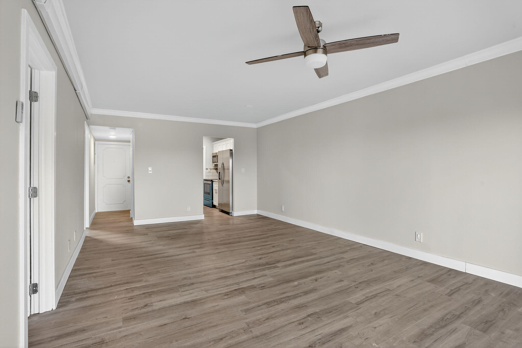 3201 Northeast 14th Street Causeway, Unit 501 Pompano Beach, FL 33062 - Photo 5 of 32 a view of an empty room with wooden floor and a window
