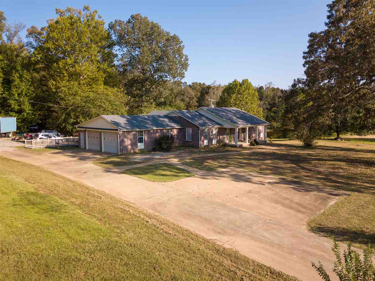 4560 Clifton Road Savannah, TN 38372 - Photo 2 of 25 a house view with a swimming pool and wooden fence