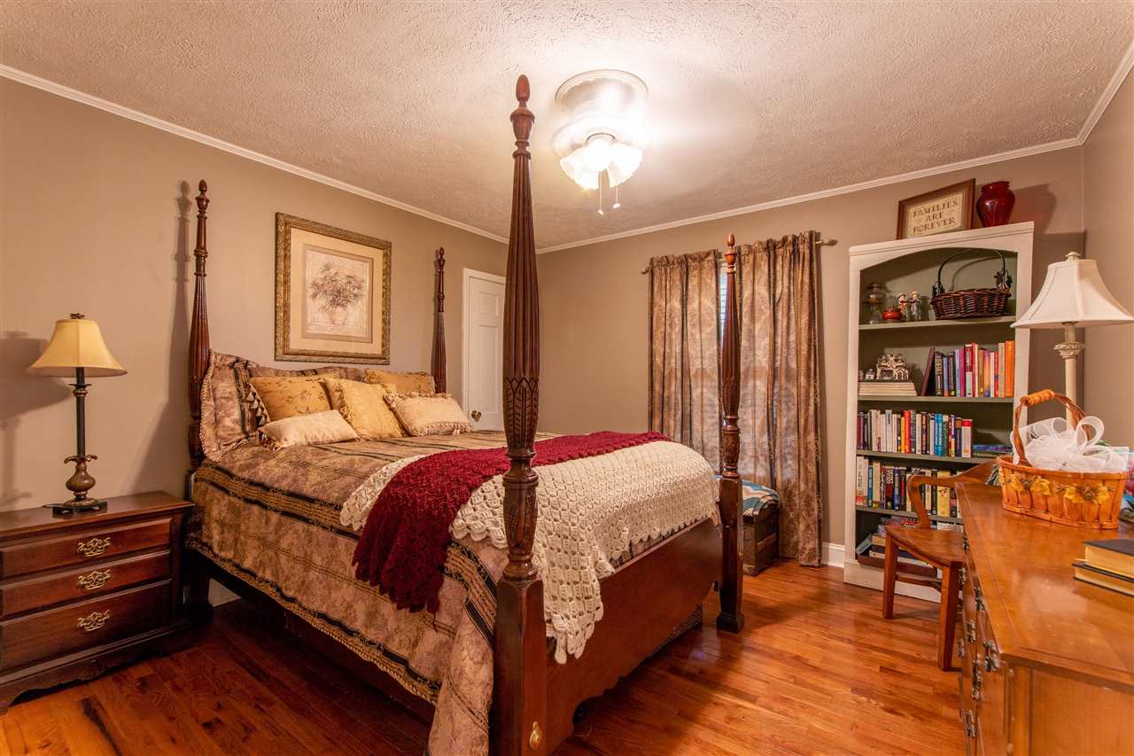 4560 Clifton Road Savannah, TN 38372 - Photo 11 of 25 a bedroom with a bed furniture and a book shelf