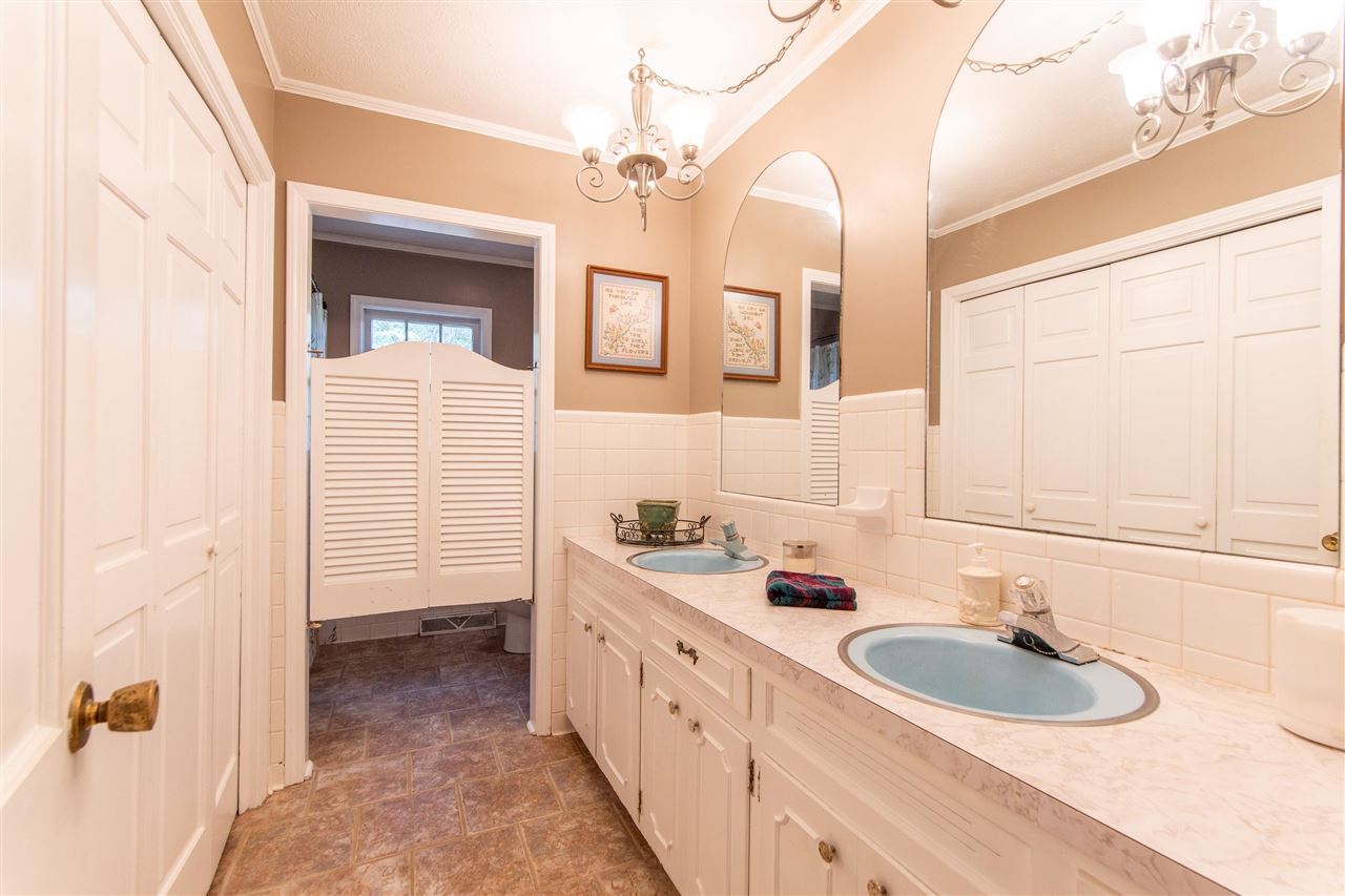 4560 Clifton Road Savannah, TN 38372 - Photo 12 of 25 a bathroom with a sink a vanity and a mirror