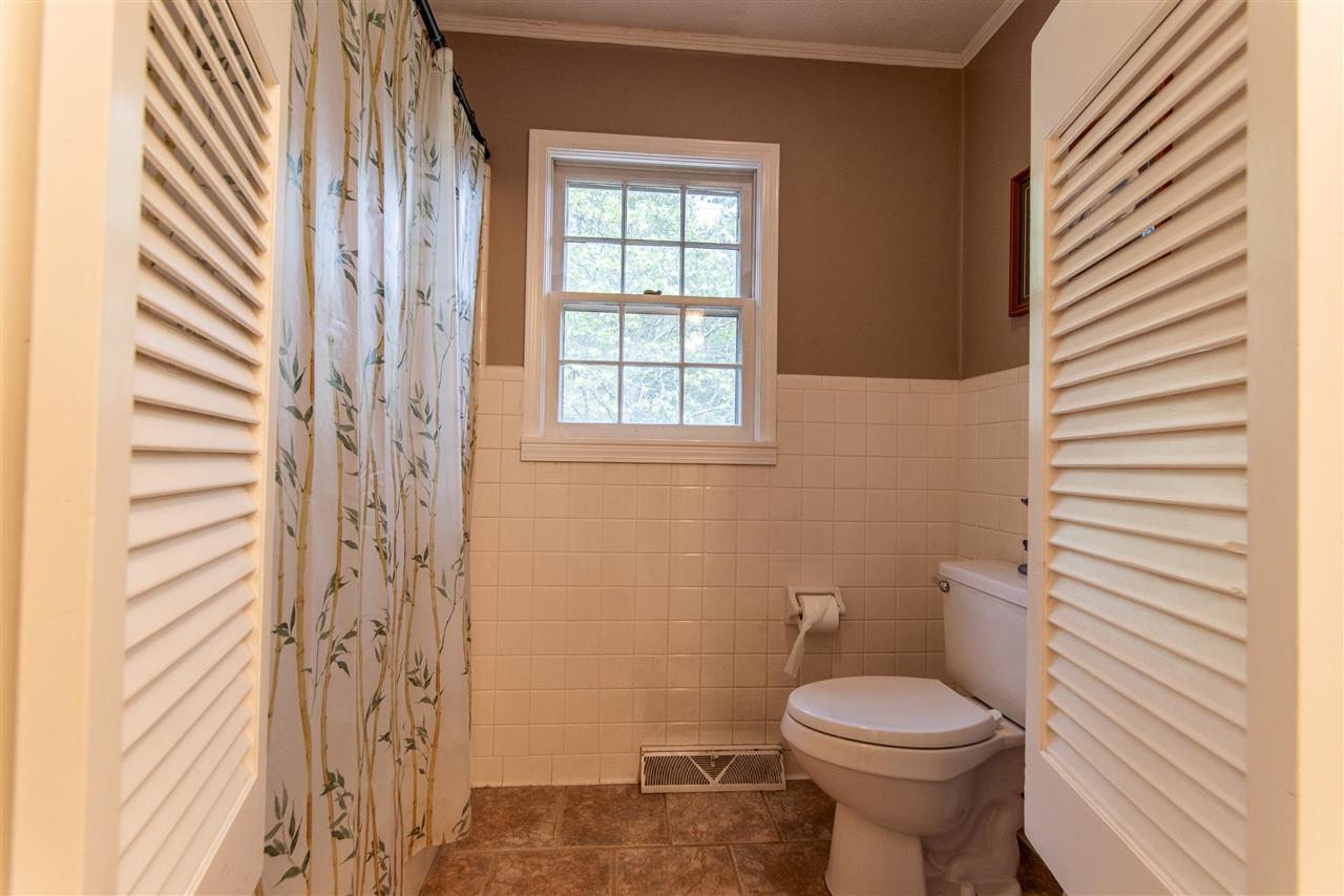 4560 Clifton Road Savannah, TN 38372 - Photo 13 of 25 a bathroom with a toilet a sink and a shower