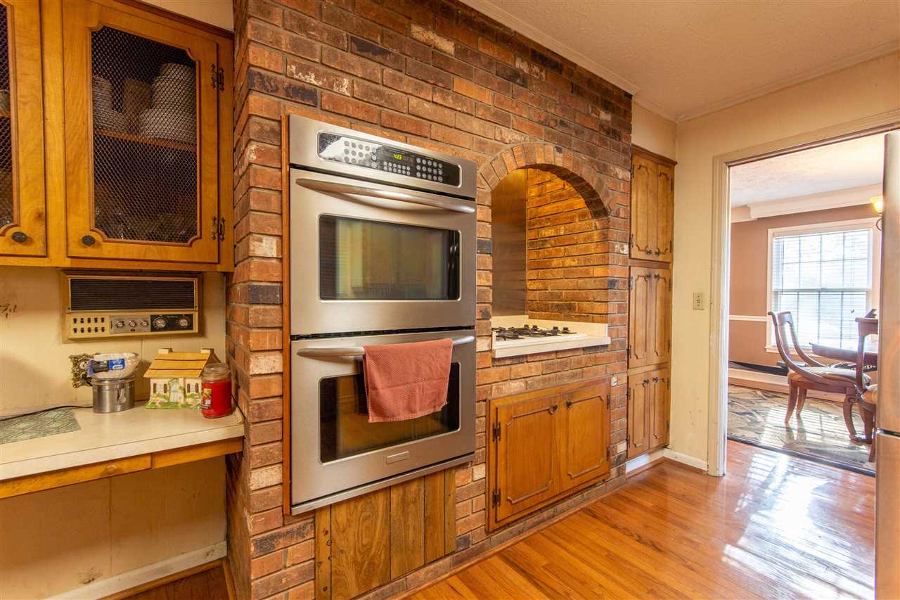 4560 Clifton Road Savannah, TN 38372 - Photo 15 of 25 a kitchen with stainless steel appliances granite countertop a stove and a microwave