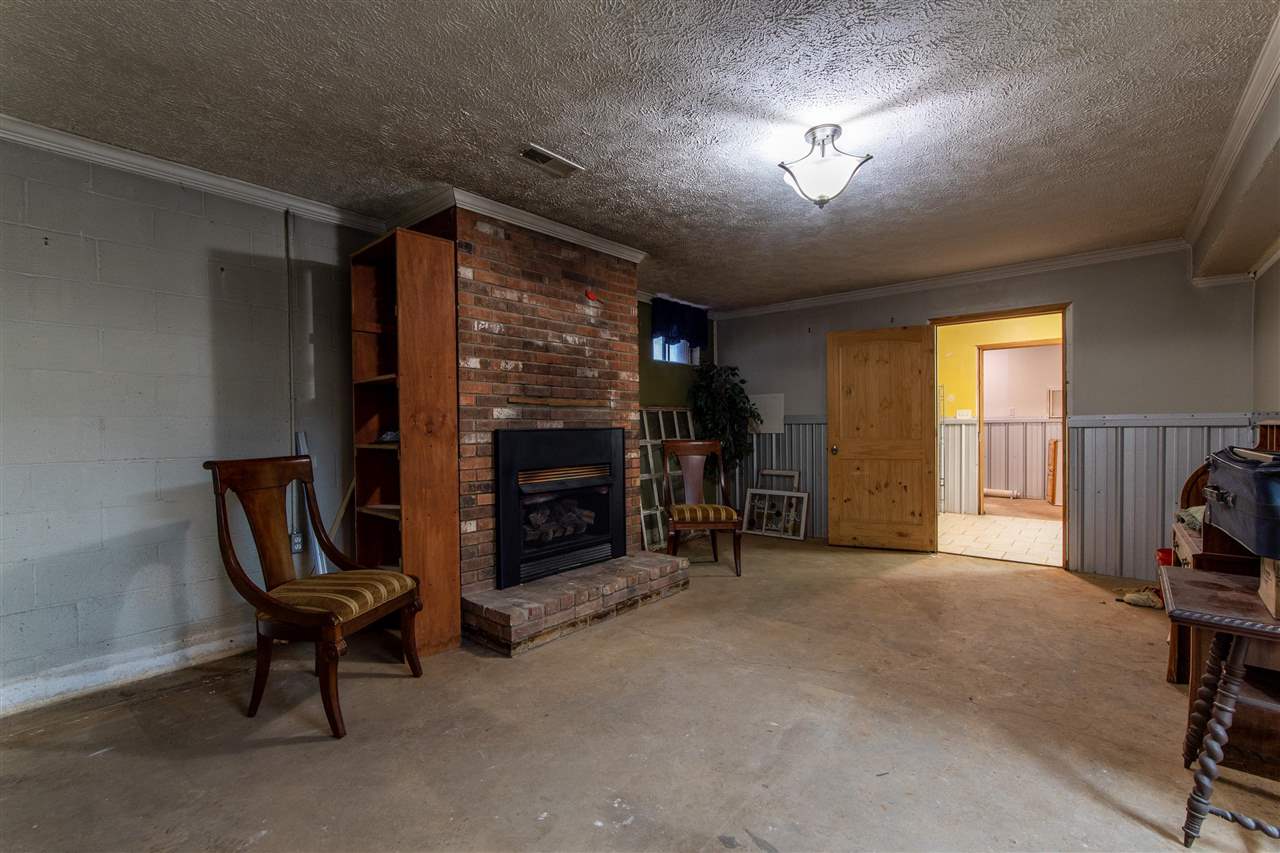 4560 Clifton Road Savannah, TN 38372 - Photo 19 of 25 a view of a livingroom with furniture and a fireplace