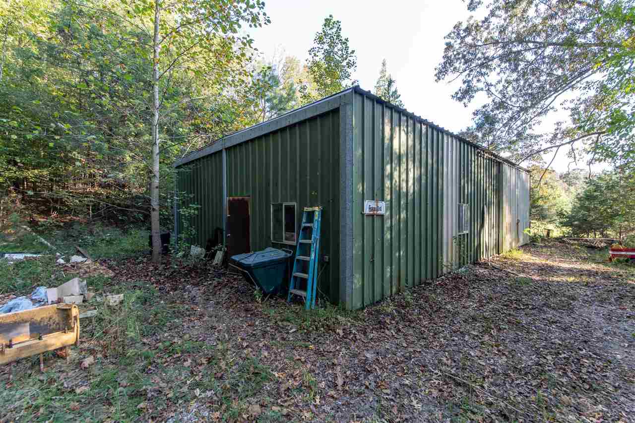 4560 Clifton Road Savannah, TN 38372 - Photo 24 of 25 a view of a backyard with plants and large trees