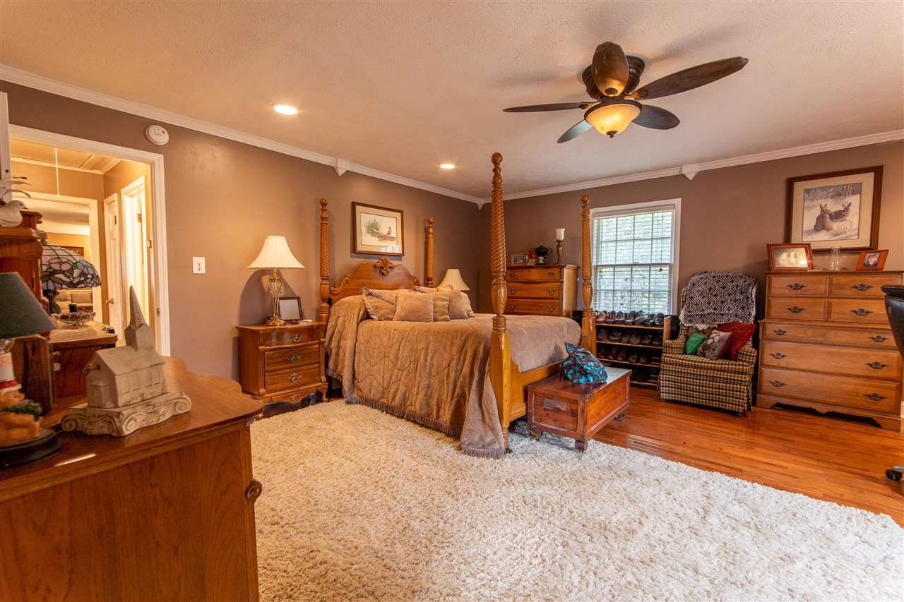 4560 Clifton Road Savannah, TN 38372 - Photo 7 of 25 a bedroom with furniture and wooden floor