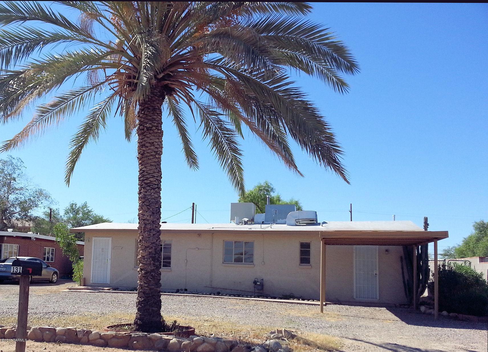131 West Navajo Road Tucson, AZ 85705 - Photo 2 of 13 a front view of a house with a palm tree