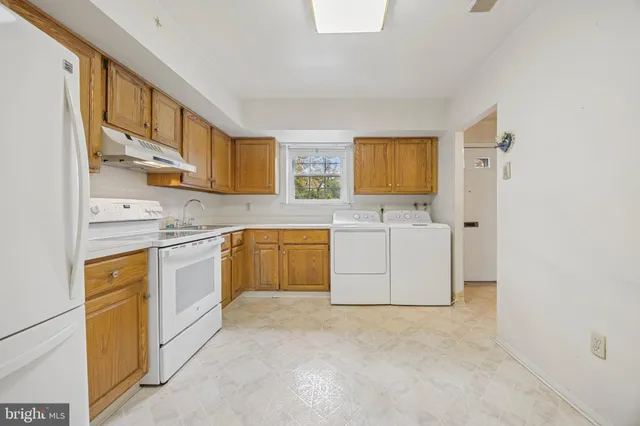 a kitchen with a stove a sink and a refrigerator