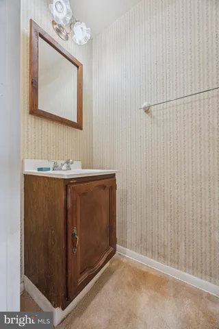 a bathroom with a sink a mirror and a vanity