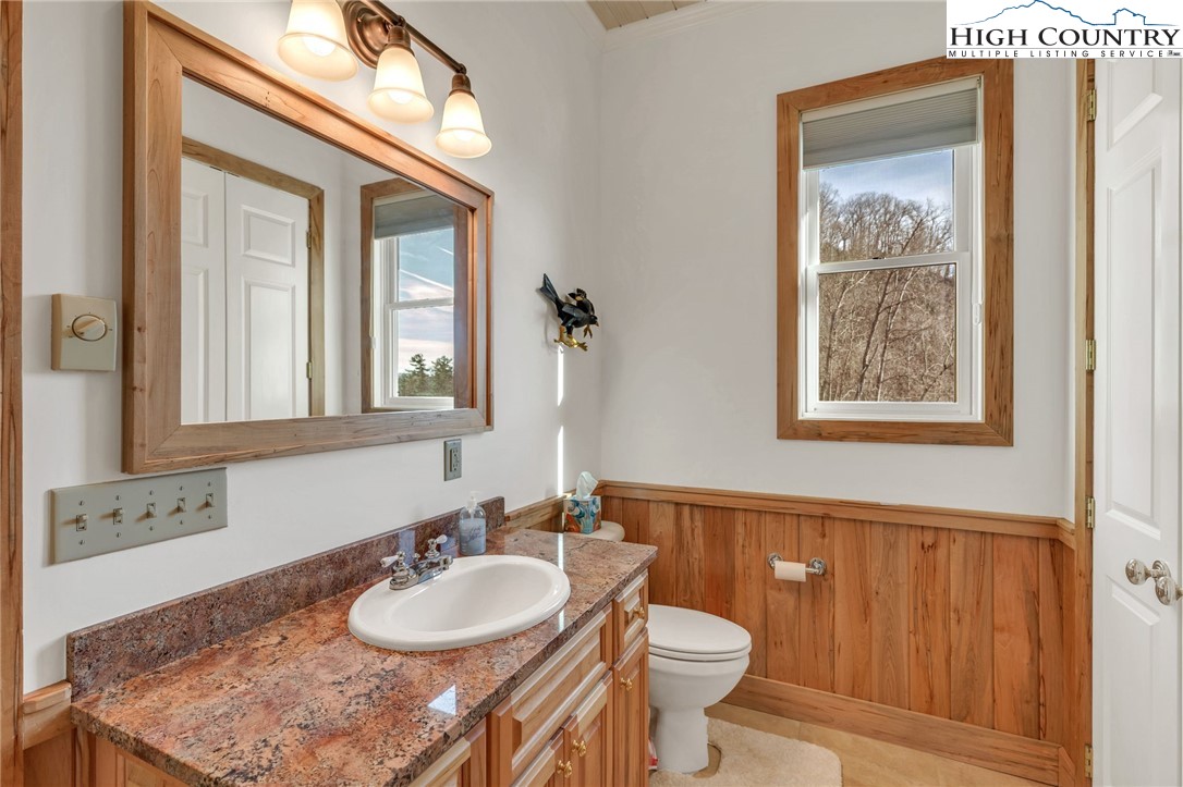 933 Thunder Ridge Lane Lenoir, NC 28645 - Photo 37 of 45 a bathroom with a granite countertop sink a toilet and a mirror