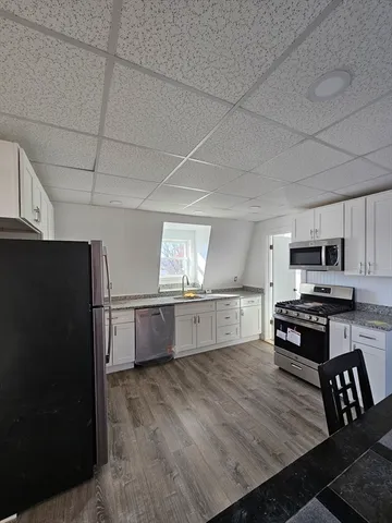 a kitchen with stainless steel appliances a stove a refrigerator and a sink