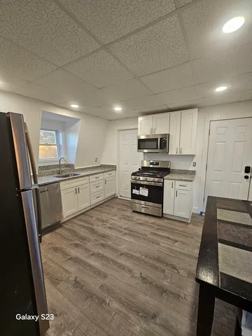 a large kitchen with cabinets and stainless steel appliances