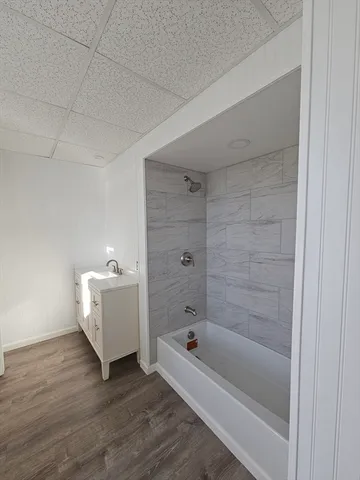 a bathroom with a bathtub and shower