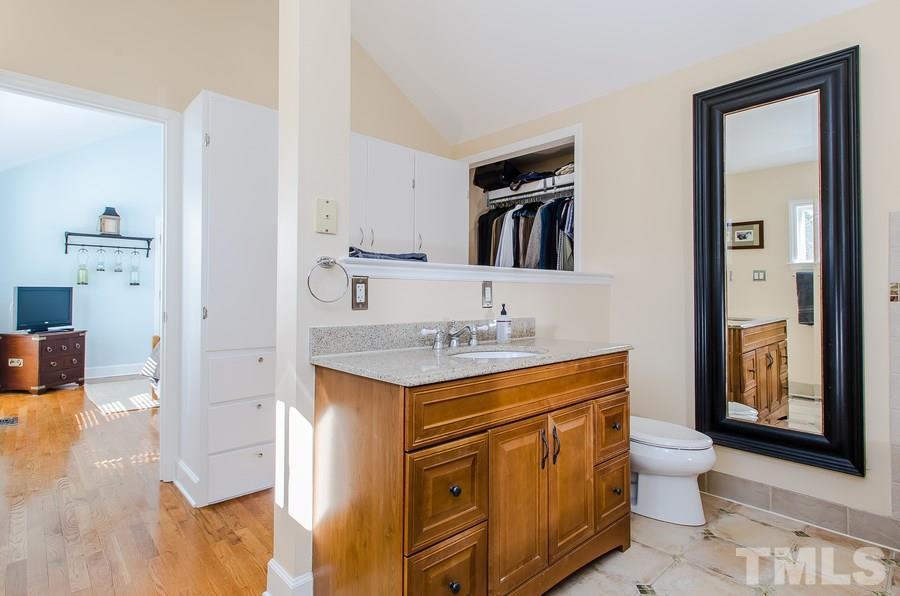 1705 Midwood Drive Raleigh, NC 27604 - Photo 14 of 24 a bathroom with a toilet sink and mirror