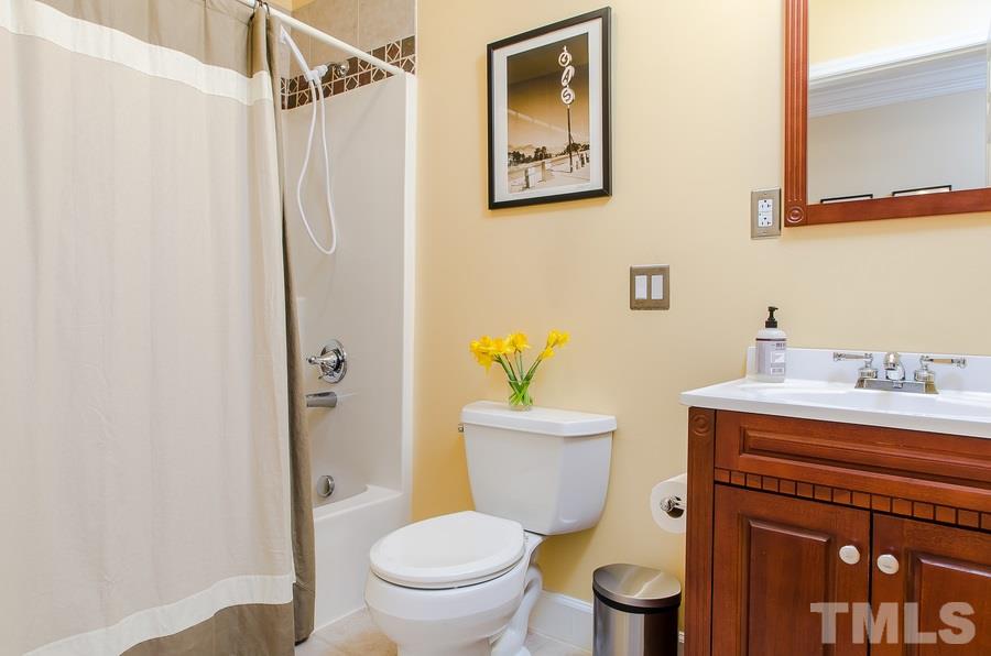 1705 Midwood Drive Raleigh, NC 27604 - Photo 16 of 24 a white toilet sitting next to a bathroom sink
