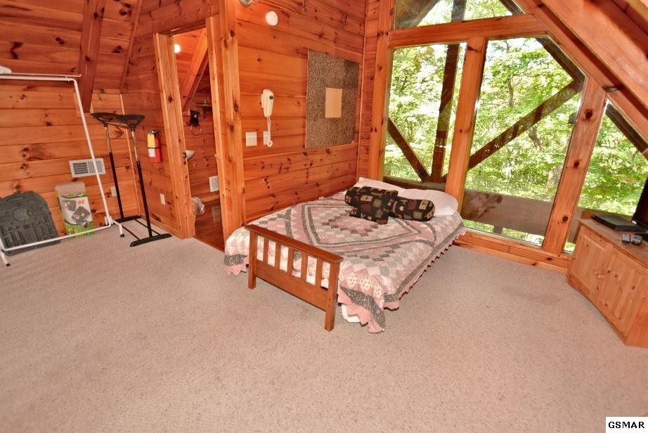524 Hideaway Ridge Circle Sevierville, TN 37862 - Photo 25 of 30 a bedroom with furniture and a large window