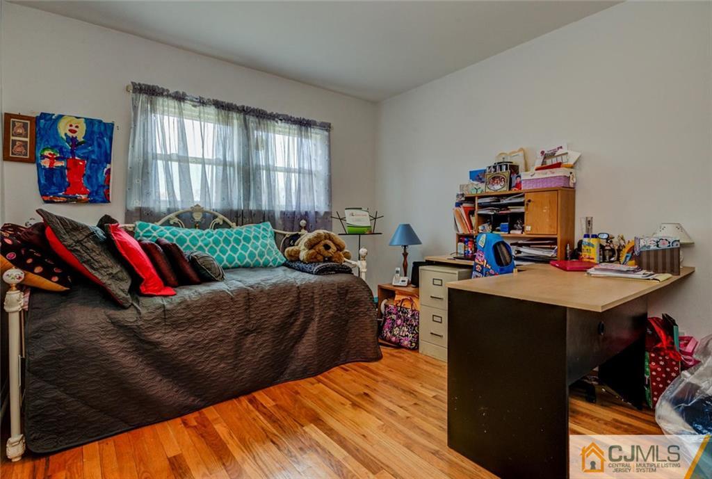 40 Smith Road Somerset, NJ 08873 - Photo 17 of 22 a living room with a bed furniture and a flat screen tv