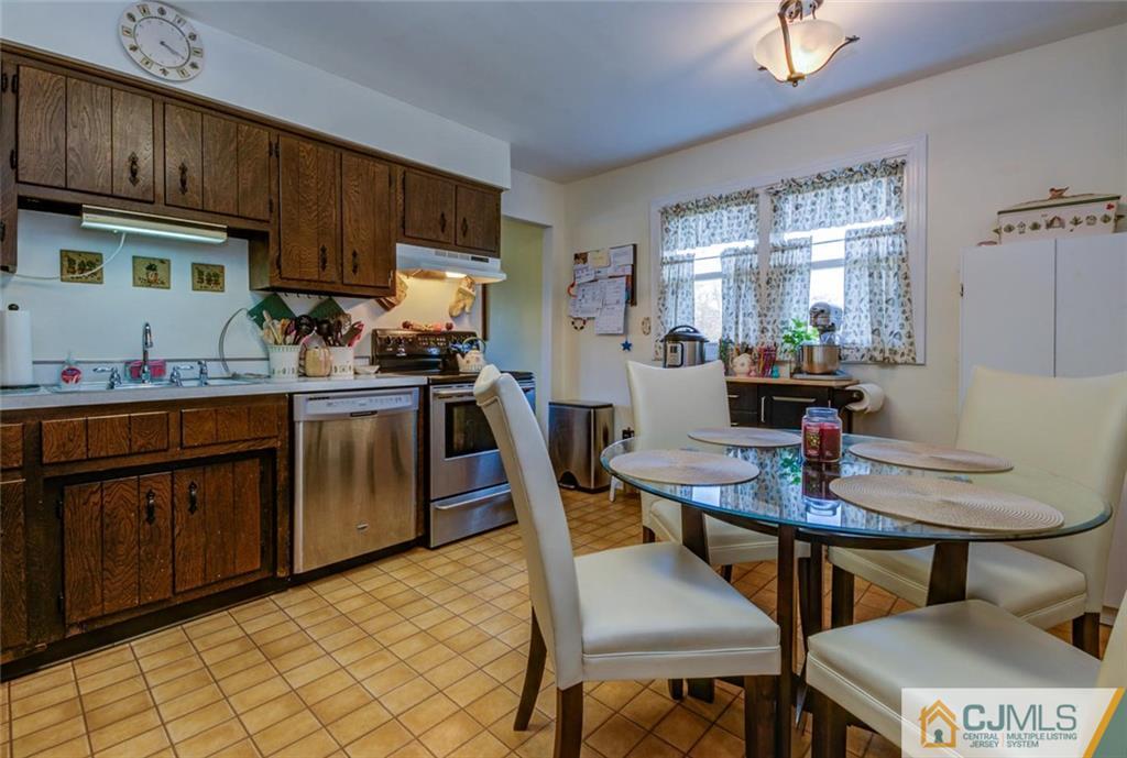 40 Smith Road Somerset, NJ 08873 - Photo 5 of 22 a kitchen with a dining table chairs and cabinets