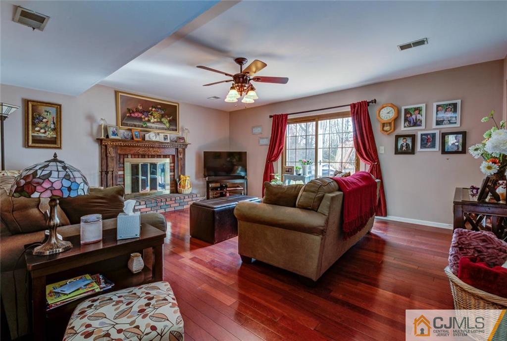 40 Smith Road Somerset, NJ 08873 - Photo 7 of 22 a living room with furniture a flat screen tv and a fireplace