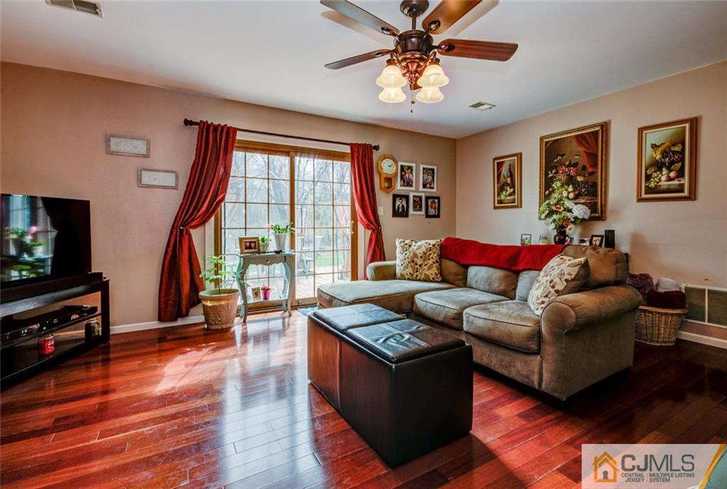 40 Smith Road Somerset, NJ 08873 - Photo 8 of 22 a living room with furniture and a flat screen tv with wooden floor
