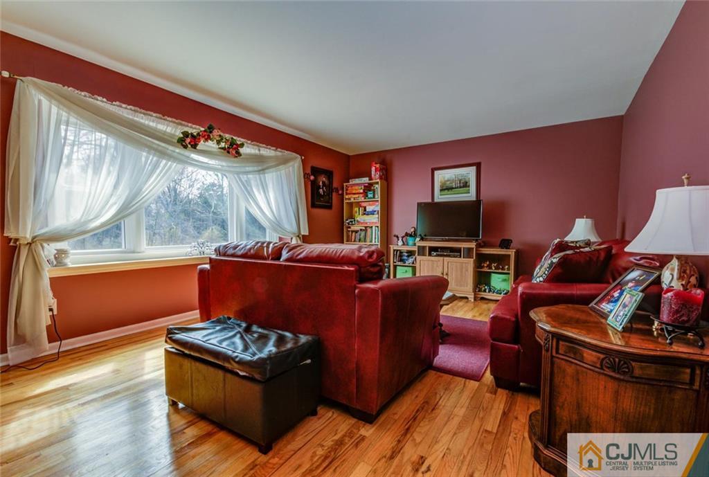 40 Smith Road Somerset, NJ 08873 - Photo 10 of 22 a living room with furniture a flat screen tv and a fireplace