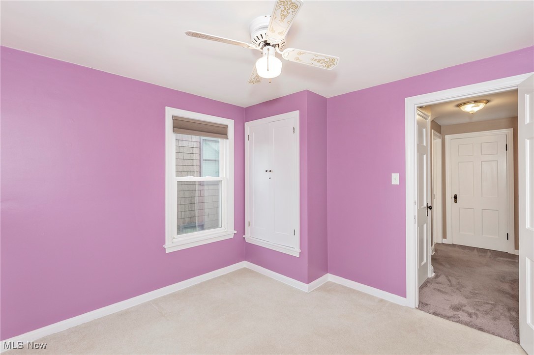 3826 Silsby Road Cleveland, OH 44118 - Photo 28 of 41 Empty room featuring light carpet, baseboards, and a ceiling fan