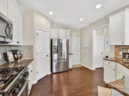 a kitchen with stainless steel appliances a refrigerator a stove a sink and cabinets