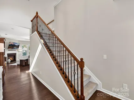 a view of entryway and hall with wooden floor