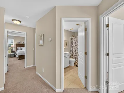 a view of a hallway with a livingroom and couch