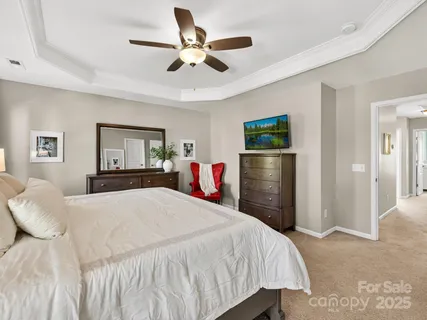 a bedroom with a bed and a chandelier