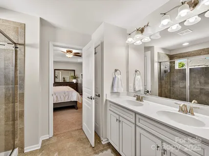 a en suite bathroom with a double sink and mirror