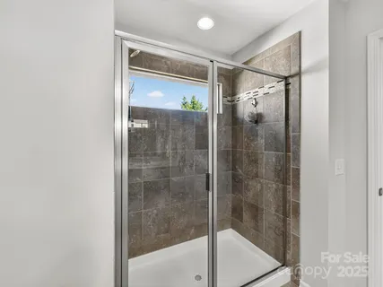 a bathroom with a glass shower door