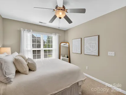 a bedroom with a bed and a large window