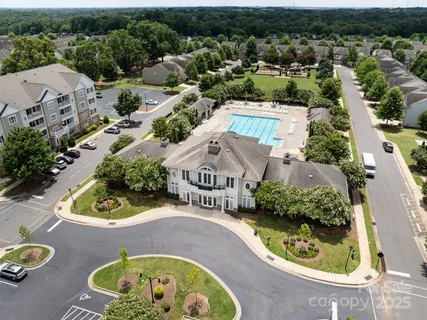 an aerial view of a house with a yard and lake view