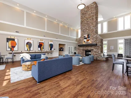 a living room with fireplace furniture and a chandelier