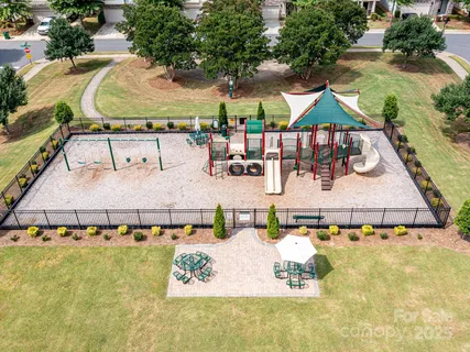 an aerial view of a swimming pool with outdoor seating