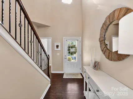 a view of a livingroom with wooden floor and stairs
