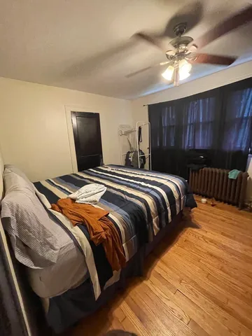 a bedroom with a bed and ceiling fan