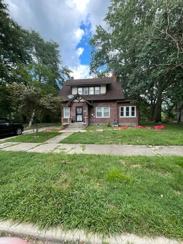 a view of a house with a yard porch and sitting area