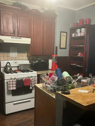 a kitchen with a sink stove and cabinets