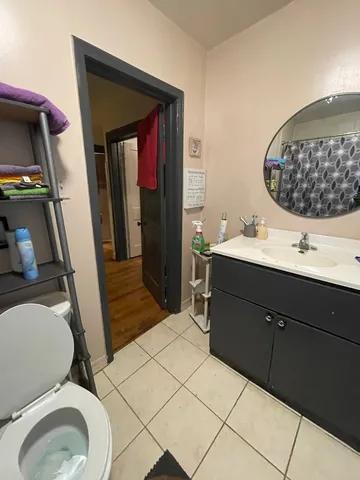 a bathroom with a sink a toilet and mirror