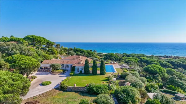 an aerial view of residential houses with outdoor space and swimming pool