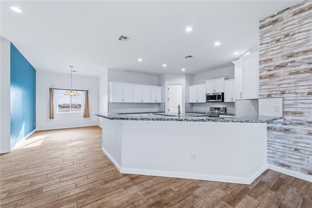 2385 Corwin Road Bullhead City, AZ 86442 - Photo 16 of 78 a view of kitchen with stainless steel appliances granite countertop cabinets and wooden floor