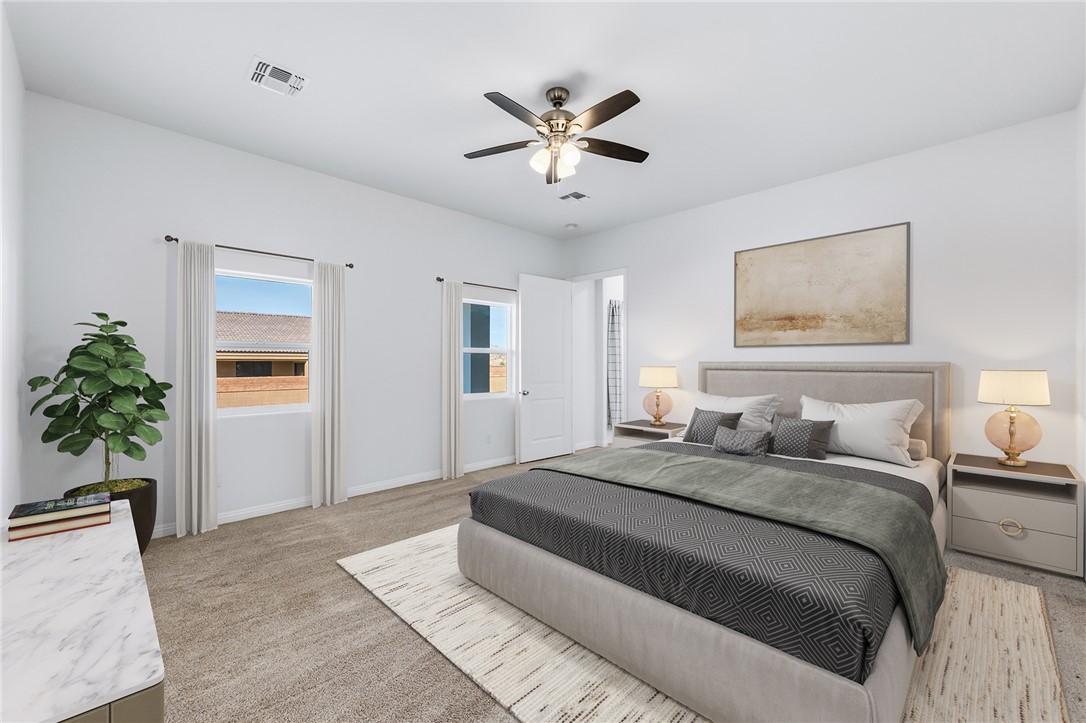 2385 Corwin Road Bullhead City, AZ 86442 - Photo 36 of 78 a spacious bedroom with a large bed and a chandelier