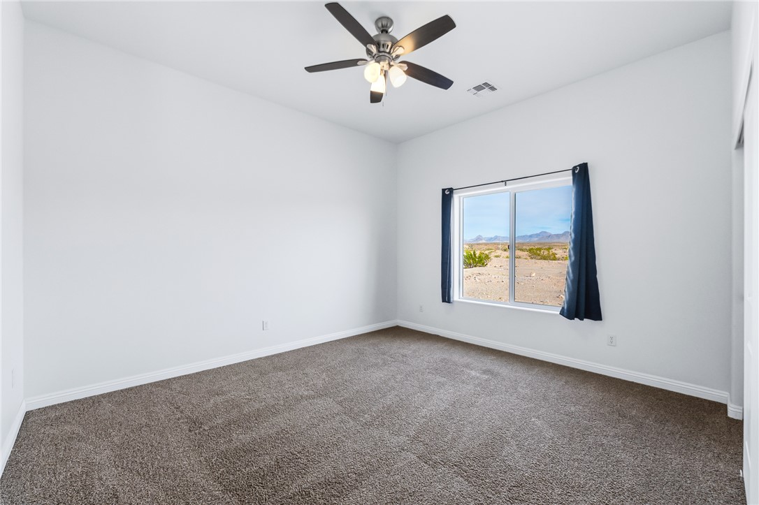 2385 Corwin Road Bullhead City, AZ 86442 - Photo 47 of 78 a view of an empty room with window and a ceiling fan