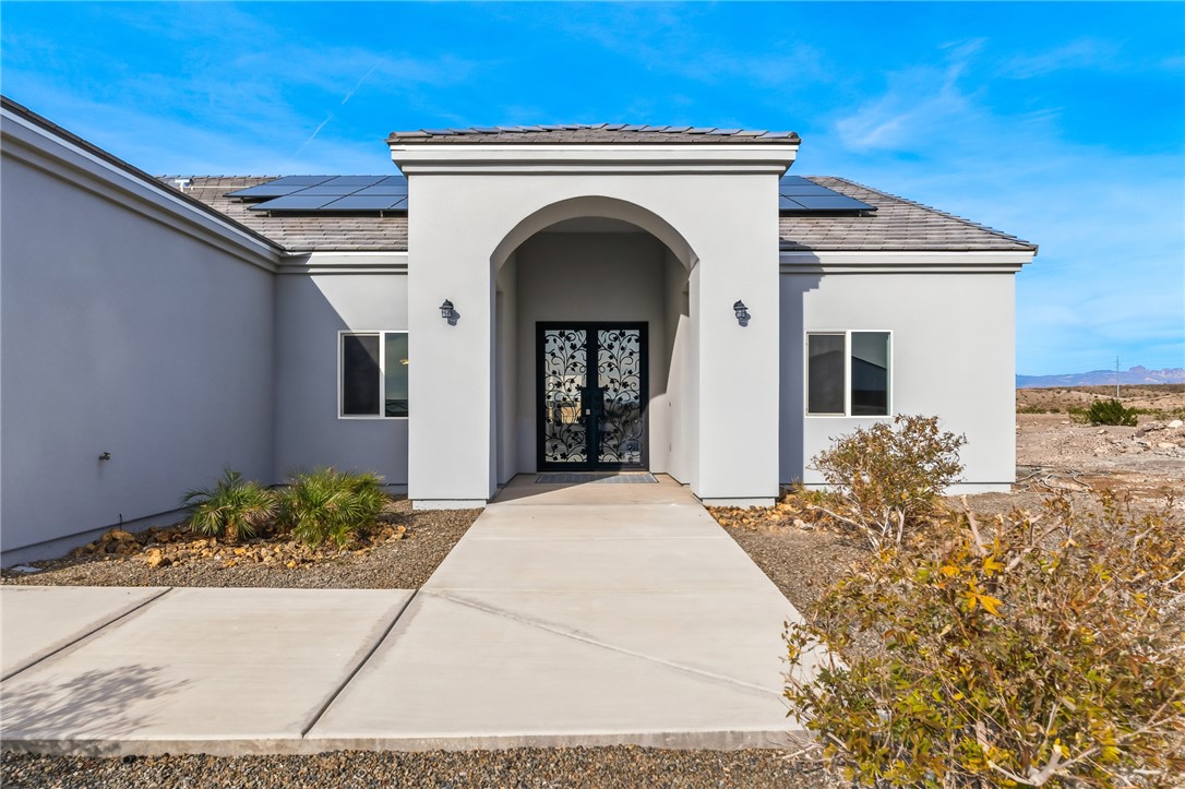 2385 Corwin Road Bullhead City, AZ 86442 - Photo 5 of 78 a front view of a house with potted plants