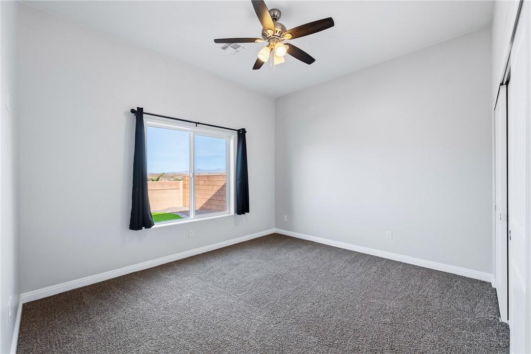 2385 Corwin Road Bullhead City, AZ 86442 - Photo 51 of 78 an empty room with a window and a fan