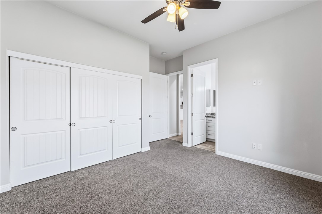 2385 Corwin Road Bullhead City, AZ 86442 - Photo 55 of 78 an empty room with a chandelier fan and windows